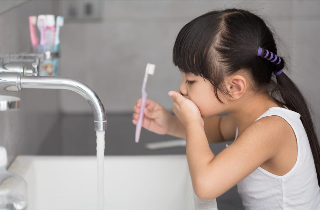 using kitchen sink brushing teeth