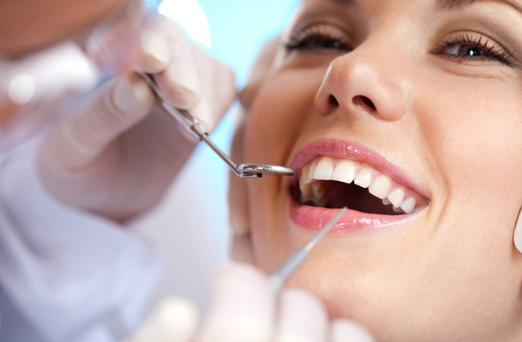 Woman with white teeth smiling at her dentist