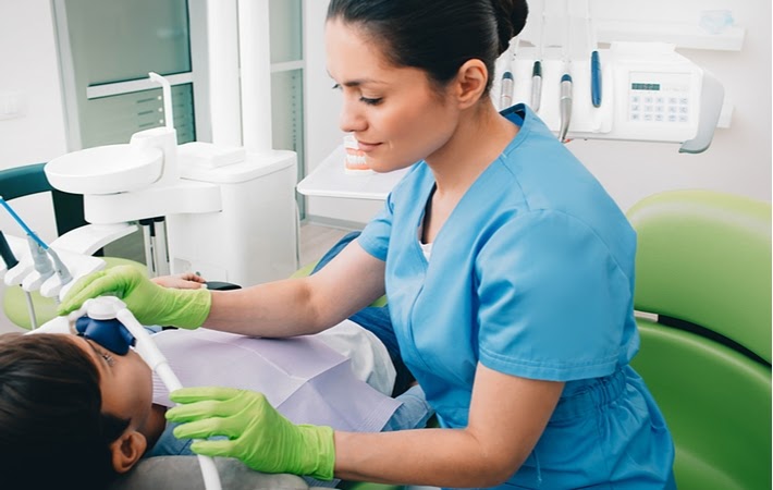 A dentist preparing a little boy for nitrous oxide to make his treatment more comfortable