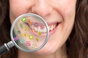 Magnifying glass showing a possible set of bacteria found if someone has bad oral health