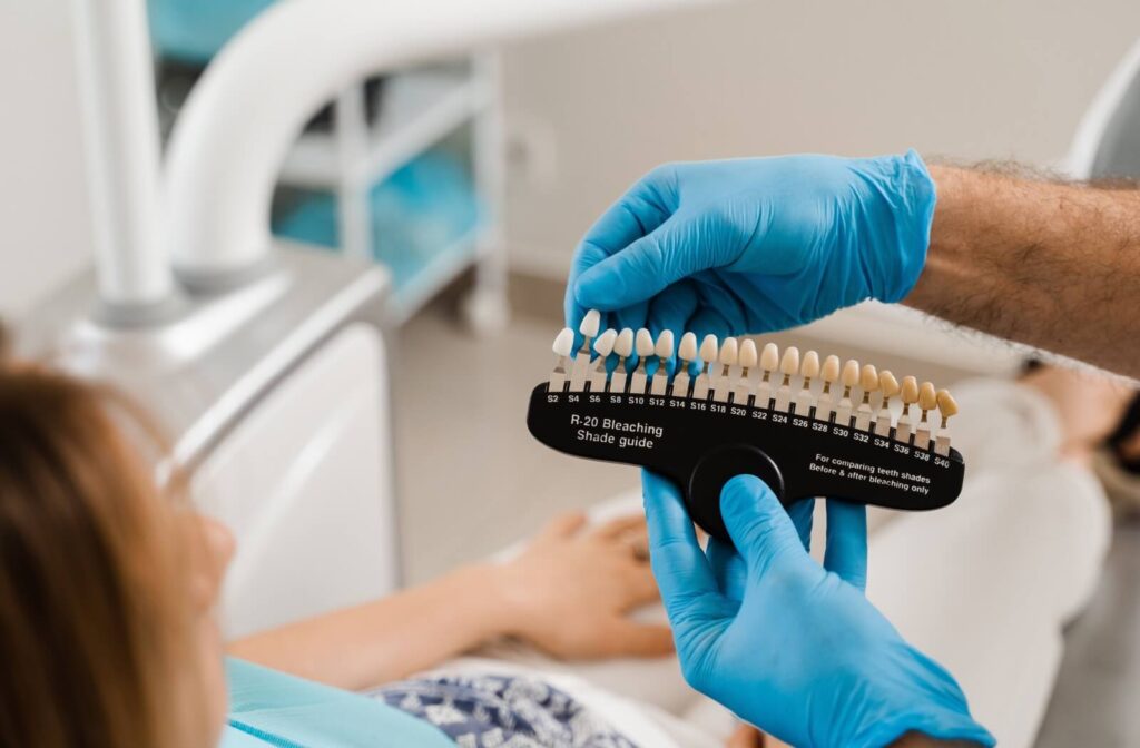 A patient looks at colour sampling to determine their preferred level of teeth brightening during their consultation.